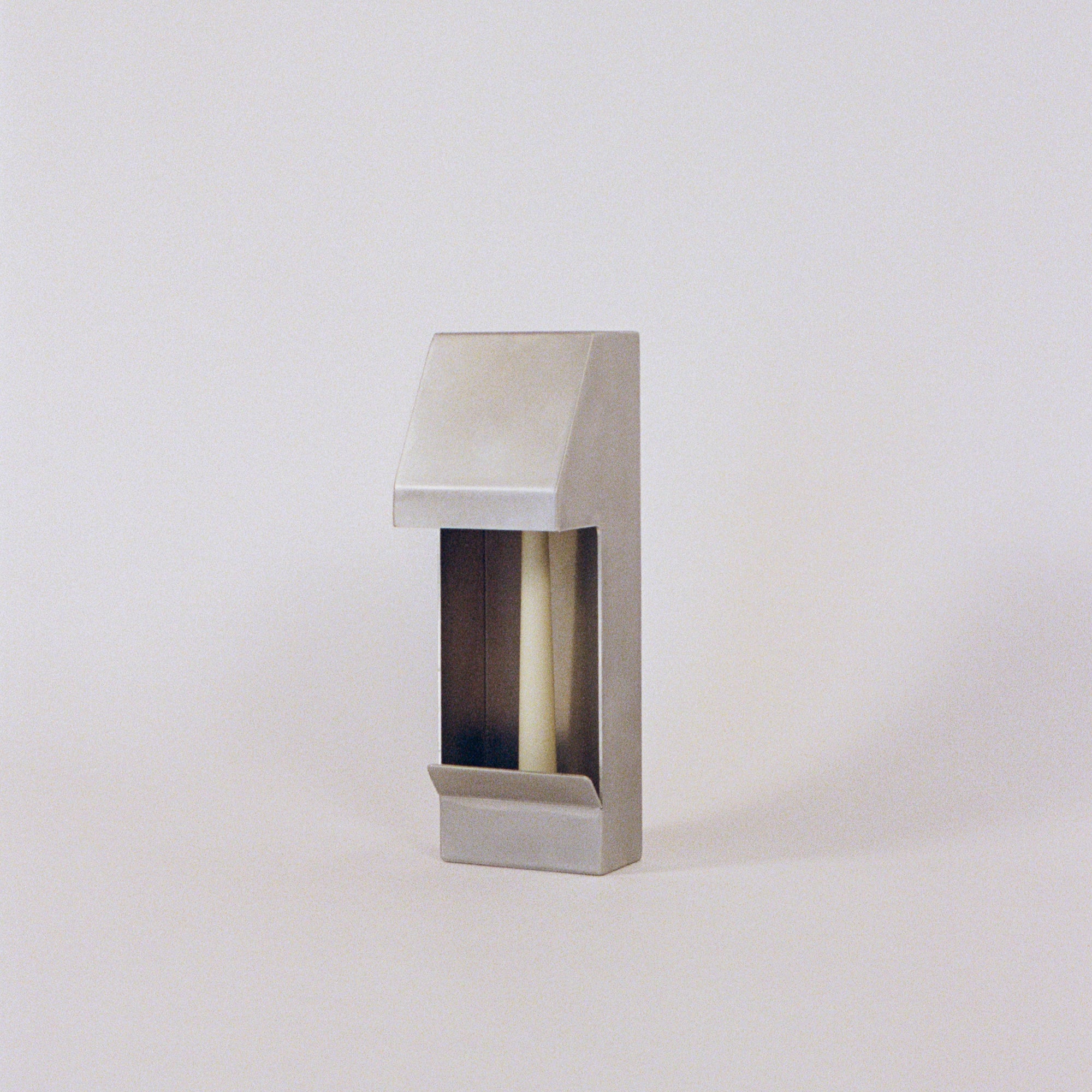 Six PARCTA taper candles in a bundle, showing tall, slender wax candles with wicks ready to light.