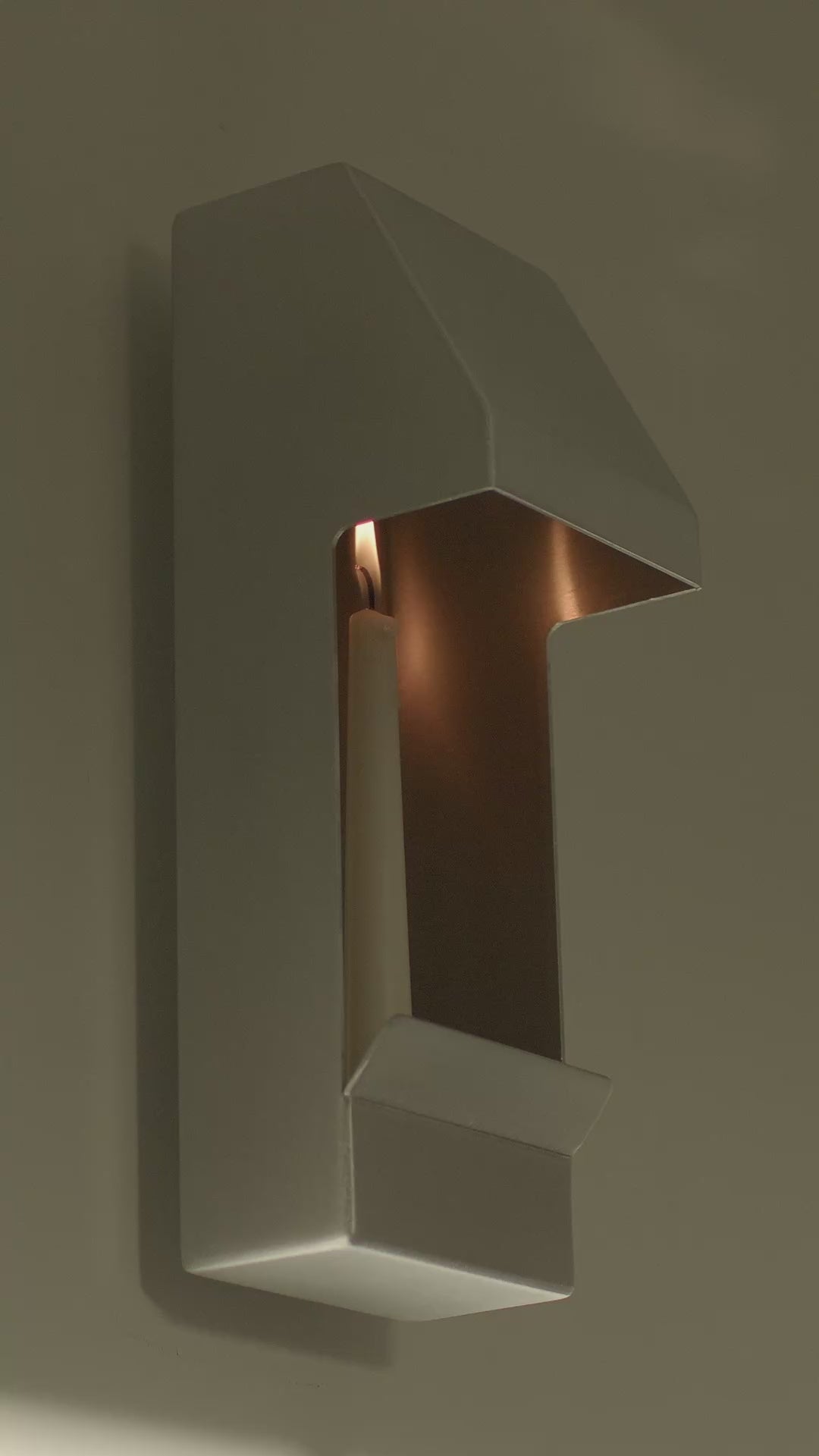 This is a video of the Egress Sconce, an aluminium taper candle holder. It is wall-mounted, providing an intriguing alternative to art or wall lighting. Each sconce comes with all required hardware and a complimentary candle. 